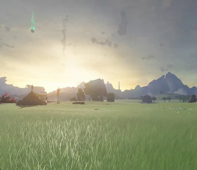 Landscape of Hyrule showing a grassy field, indistinct ruins, and mountains.